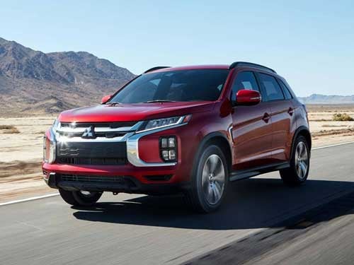 Red 2023 Mitsubishi Outlander Sport driving on a road in Texas