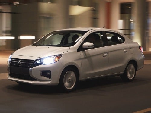 2024 Mitsubishi Mirage G4 driving on a city street at night